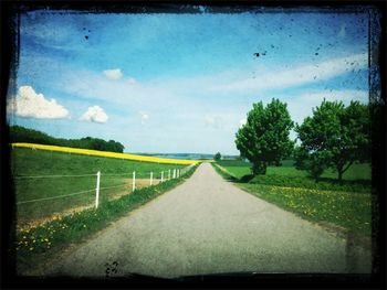 Road passing through field