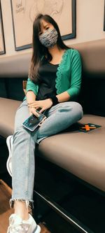 Full length of woman using mobile phone