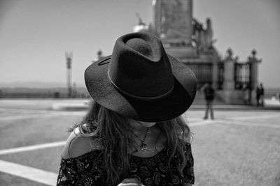 Rear view of woman wearing hat against sky