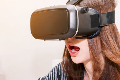 Young woman virtual reality while sitting at home