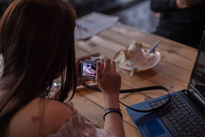 Midsection of woman using smart phone