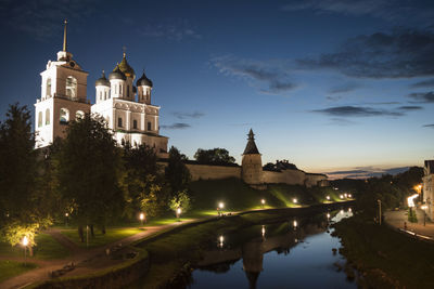 Canal amidst illuminated buildings against sky at night