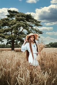 Woman standing in field against sky