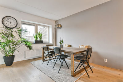 Empty chairs and table against wall at home