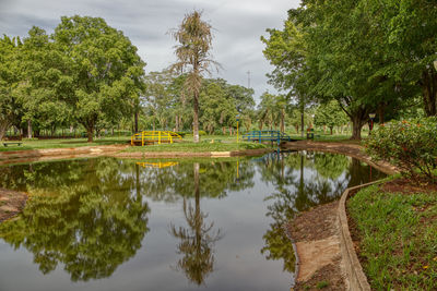 Scenic view of lake by trees against sky