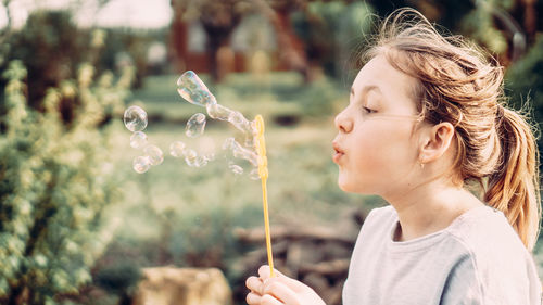 Portrait of girl looking at bubbles