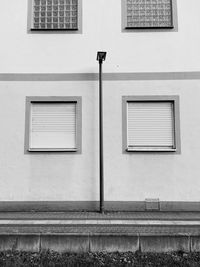 Low angle view of street light against building