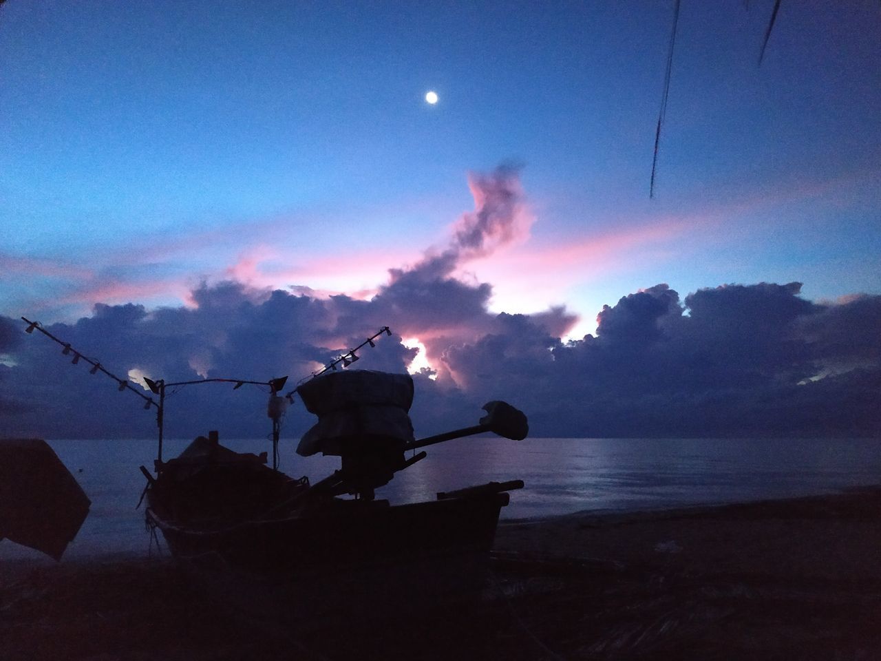 SILHOUETTE SHIP ON BEACH AGAINST SKY DURING SUNSET