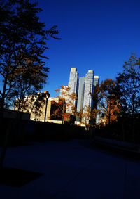 Buildings against clear blue sky