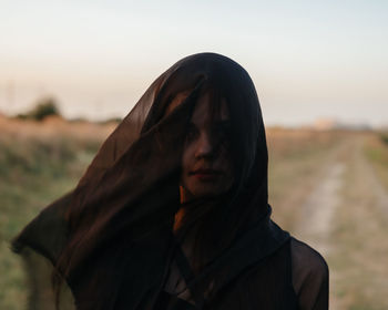 Portrait of woman standing against sky during sunset