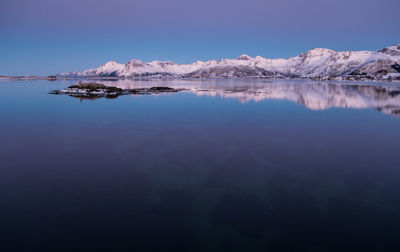 Scenic view of lake against clear blue sky