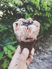 Close-up of hand holding ice cream