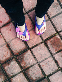 Low section of women standing on footpath