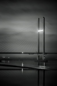 View of suspension bridge against cloudy sky