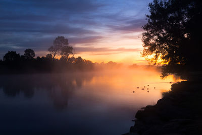 Scenic view of lake against sky during sunset