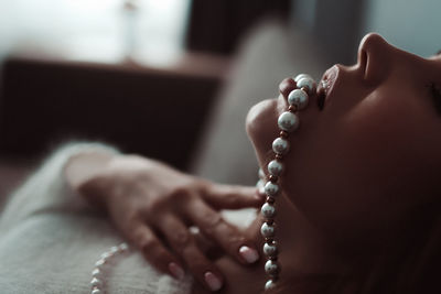 Seductive woman with pearl necklace