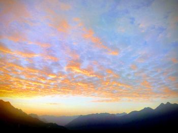 Low angle view of dramatic sky during sunset