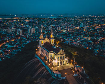 High angle view of illuminated buildings in city at night