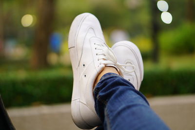Low section of woman wearing shoes outdoors
