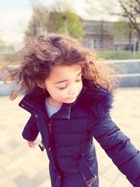 Close-up of cute girl looking away while at park