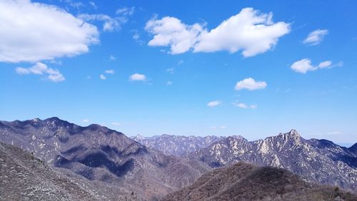 Scenic view of mountains against blue sky