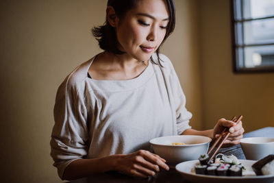 Midsection of woman holding food at home