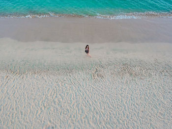 High angle view of woman standing at beach