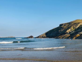 Scenic view of sea against clear blue sky