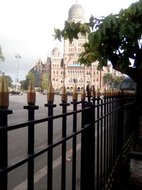 Panoramic view of trees and building against sky