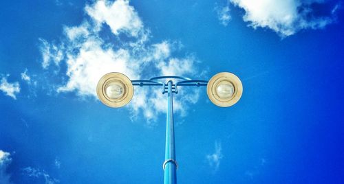 Low angle view of street light against blue sky