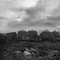 Buildings against cloudy sky