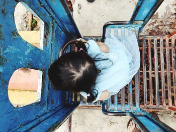 High angle view of girl playing on outdoor play equipment