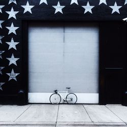 Bicycle parked against wall