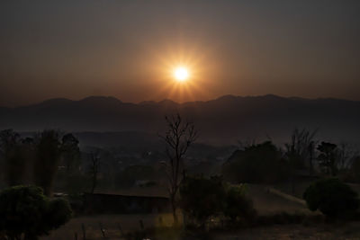 Scenic view of silhouette mountains against sky at sunset