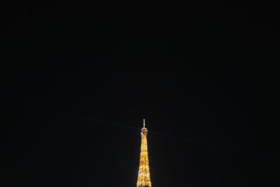 Low angle view of illuminated building against clear sky at night