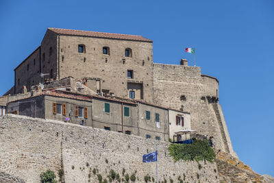 Low angle view of historical building against blue sky