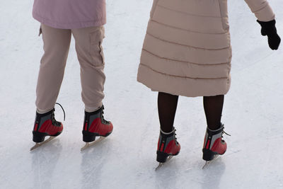 Low section of people standing on snow