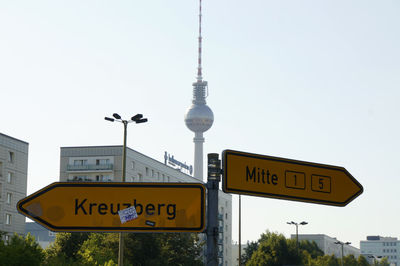 Low angle view of road sign against clear sky