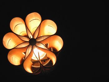 Low angle view of electric lamp against black background