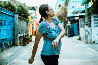 Full length of young woman looking at city