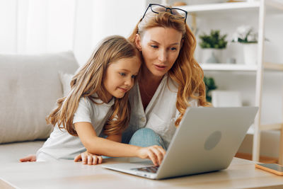 Young woman using laptop at home