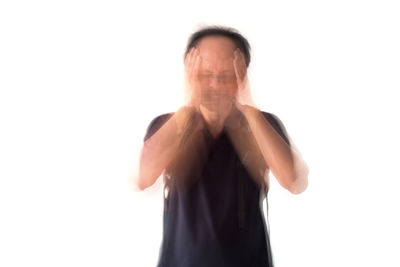 Portrait of man standing against white background