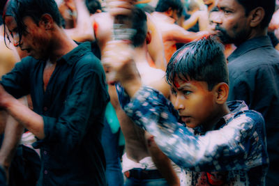 Group of people dancing on street in city