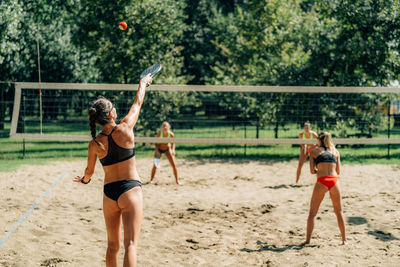 Beach tennis player serving the ball