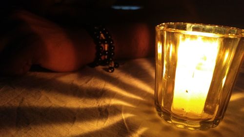 Close-up of illuminated lamp on table