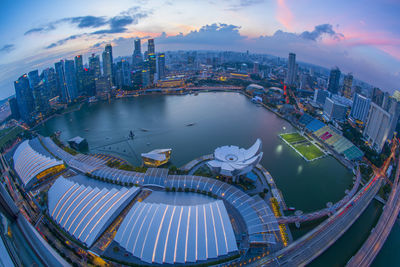 High angle view of city buildings against cloudy sky