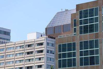 Low angle view of modern buildings against clear sky