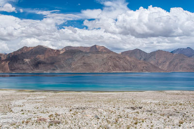 Scenic view of lake and mountains against sky