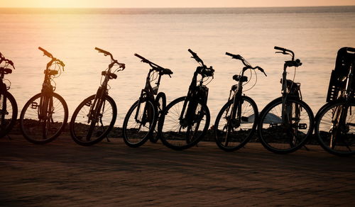 Row of bicycles at the beach in sunset