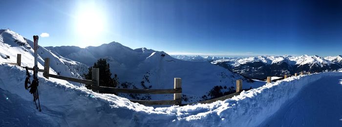 Panoramic view of snowcapped mountains against blue sky